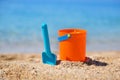 Bright plastic children`s beach toys on sand near sea. Summer vacation concept Royalty Free Stock Photo